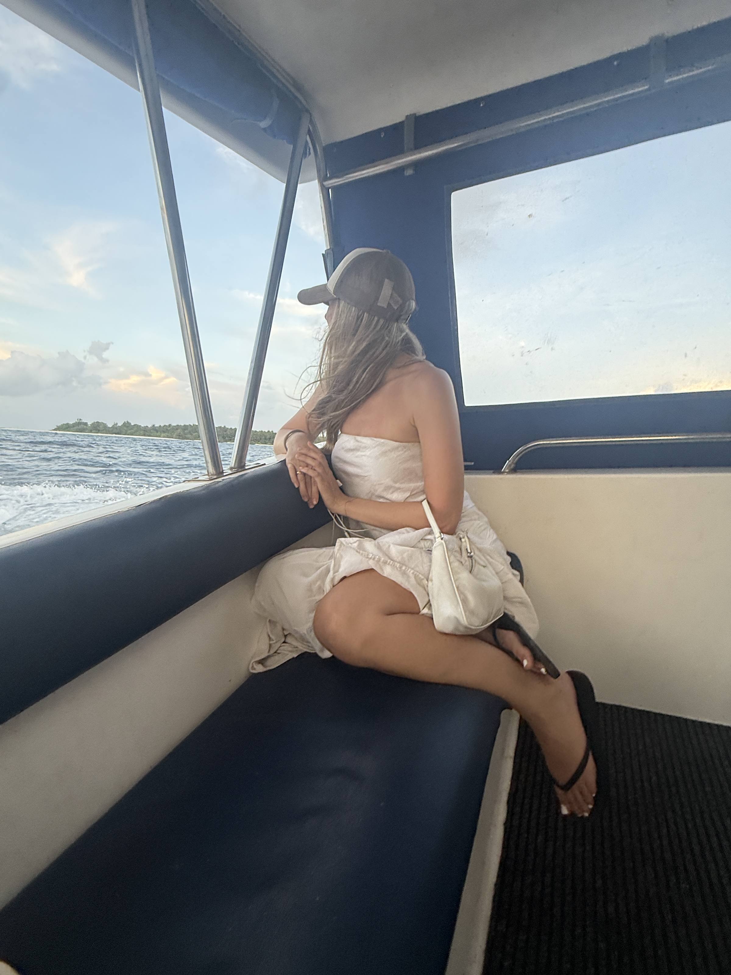 Sitting on the bench of a boat, sea through the window