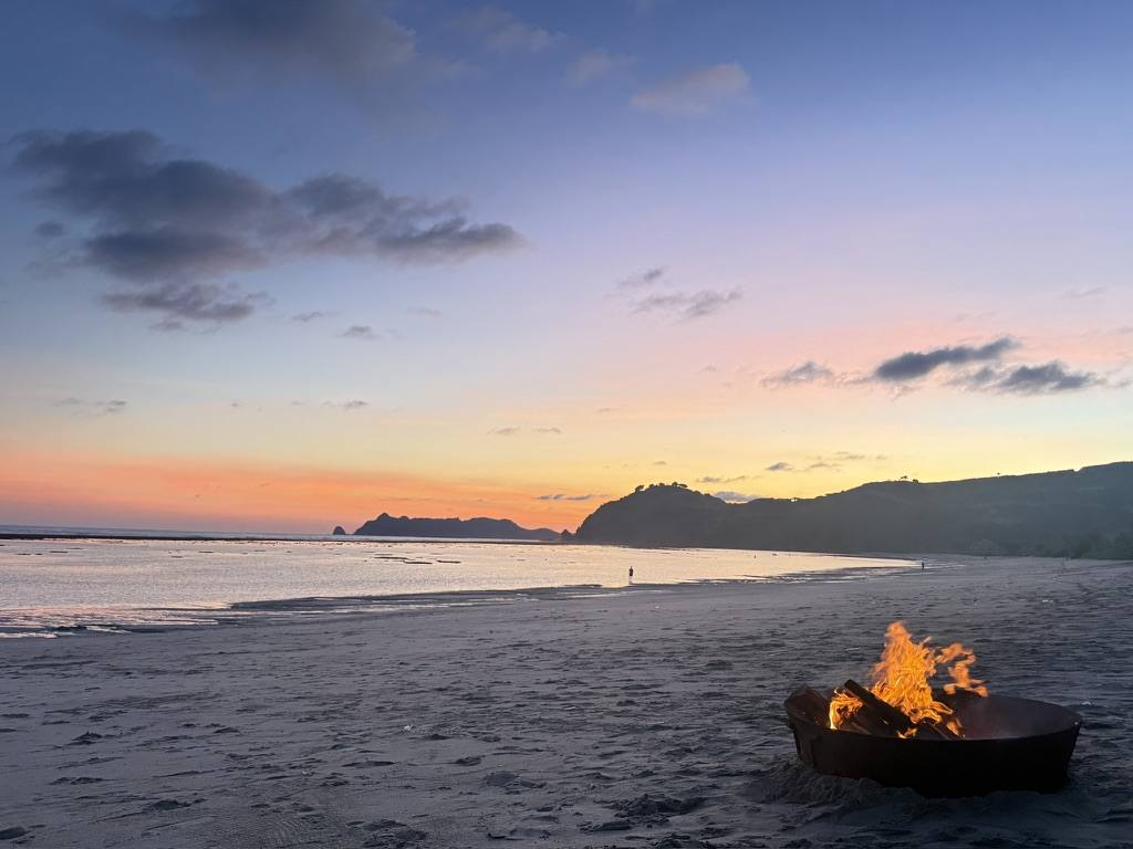 Bonfire on an empty beach at sunset