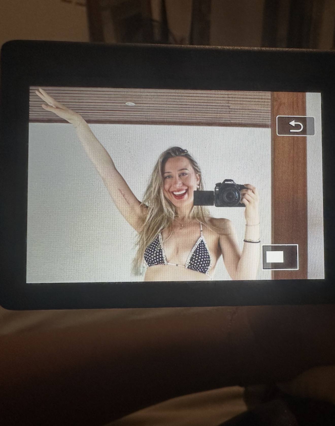 Holding a camera up, mirror