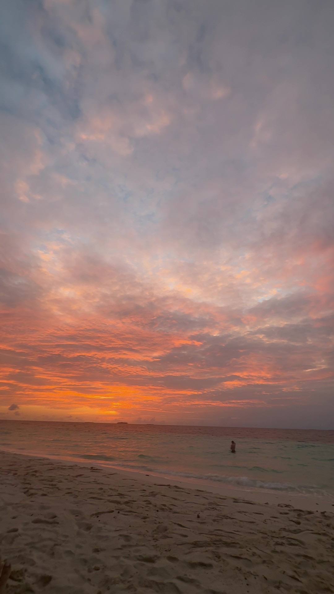 A pink and orange sunset over the water