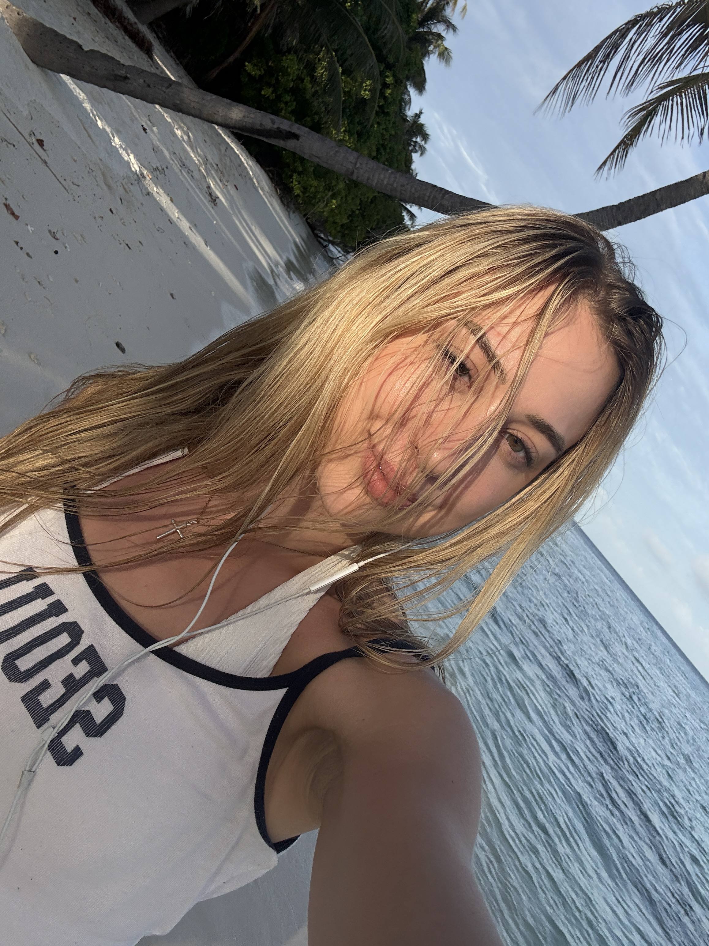 Wind-blown hair on a boat, sea behind